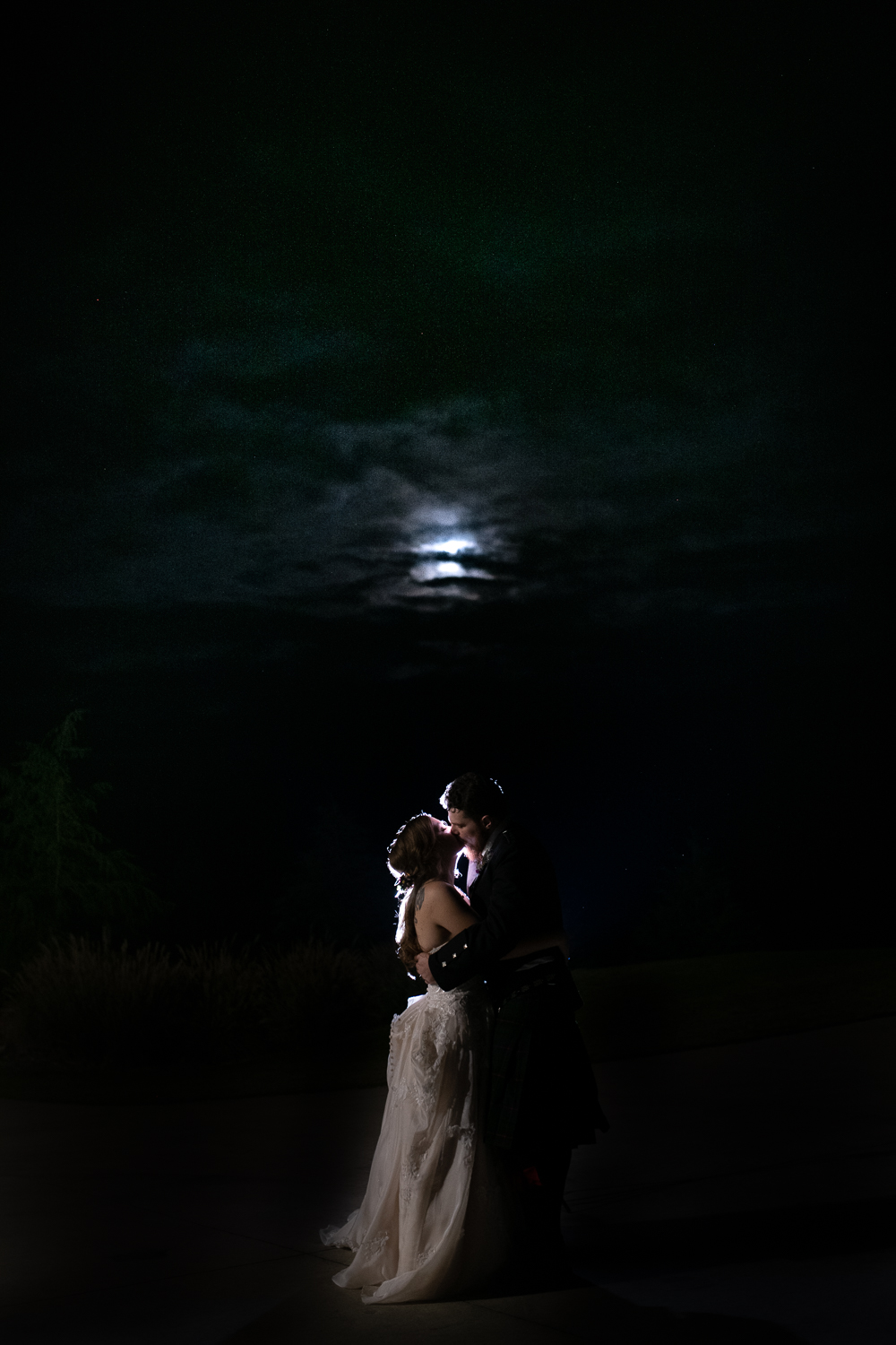 wedding couple in front of moon