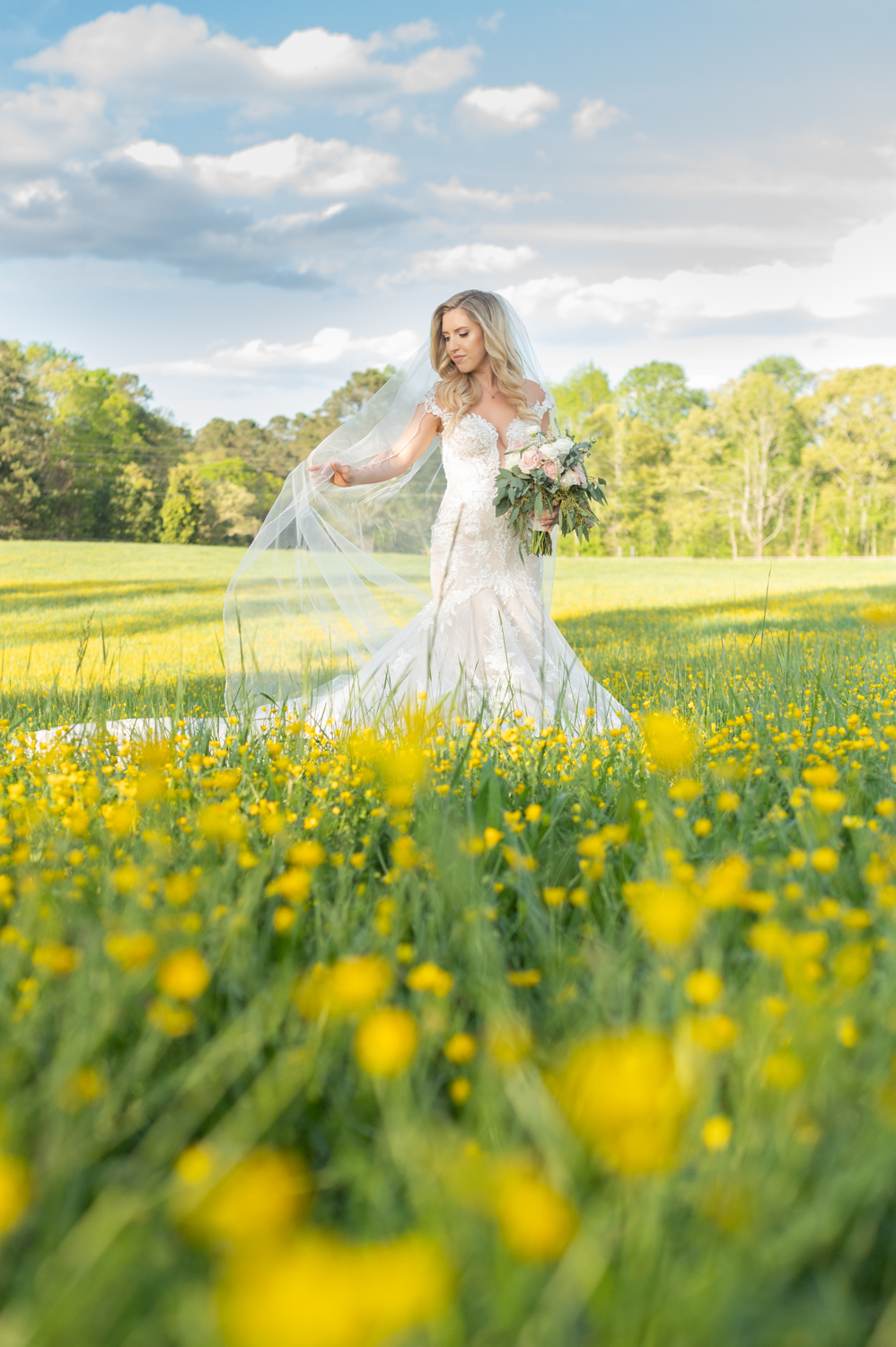 bride in field of yellow flowers