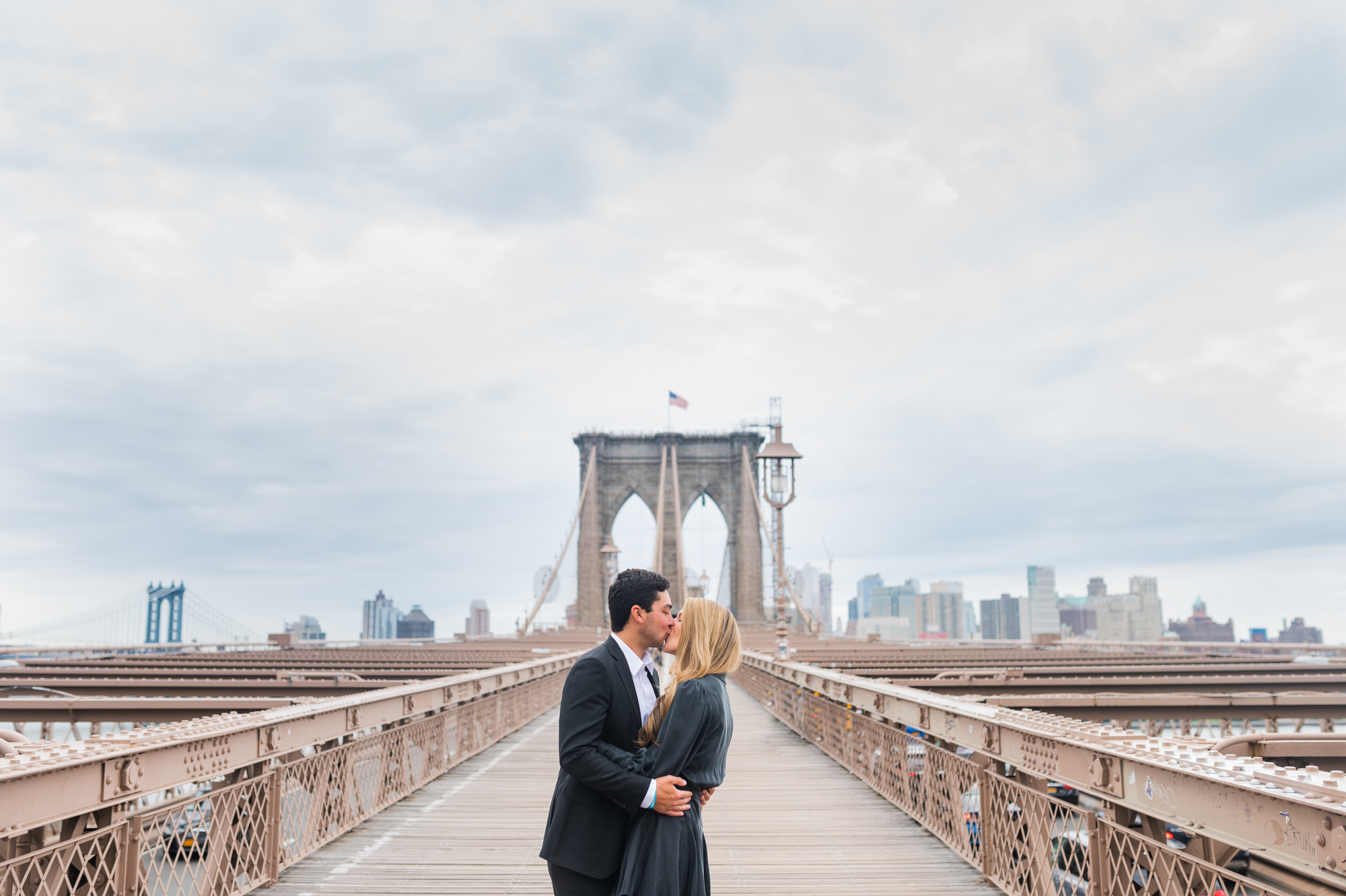 wide shot of kissing on the Brooklyn Bridge